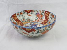 A small orange and white ground Oriental style fruit bowl, 21cm dia.