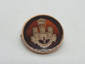 A 9ct gold and tortoiseshell regimental sweetheart brooch for the Suffolk Regiment, hallmarked 375,