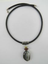 An agate pendant with white metal mount on black rubberised necklace having 925 silver clasp.