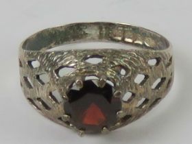 A hallmarked silver red stone ring, pierced lattice design, HM for Birmingham, size O-P.