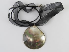 A mother of pearl pendant on ribbon necklace having 925 silver clasp.