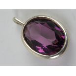 A faceted purple stone pendant, no apparent hallmarks, 2.3cm in length.