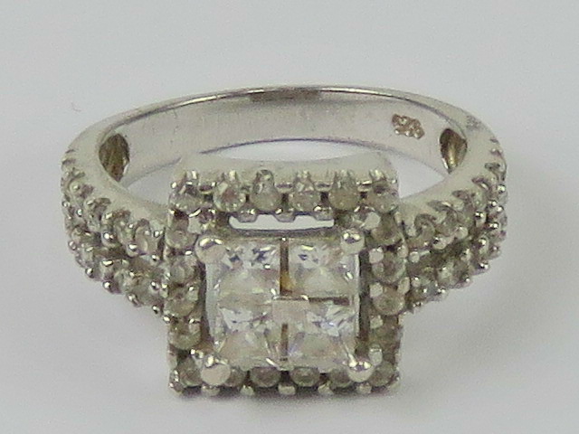 A contemporary silver and cz cluster ring, square shaped with double row band, stamped 925,