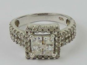 A contemporary silver and cz cluster ring, square shaped with double row band, stamped 925,