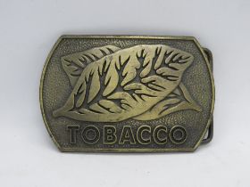 A vintage RJ Reynolds Tobacco USA belt buckle, RJ copyright mark to back.