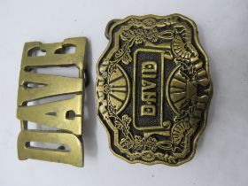 Two belt buckles, Dave and David.