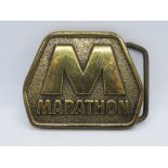 A vintage brass Marathon belt buckle made by Blue Bayou Brass Houston TX USA