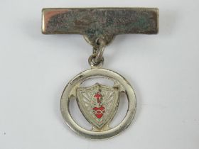 A hallmarked silver Sacred Heart enamelled brooch, 3cm in length.