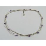 A Sterling silver Native American style five row silver beaded and amethyst necklace.