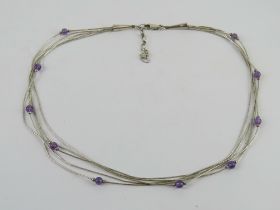 A Sterling silver Native American style five row silver beaded and amethyst necklace.