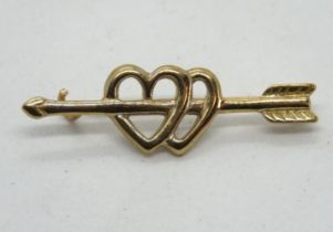 A yellow metal sweetheart brooch having double heart pierced by Cupids Arrow, no apparent hallmark,