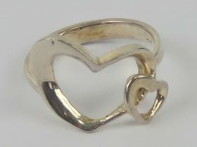 A silver ring in the form of two hearts, stamped 925, size M.