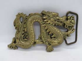 A brass Baron Buckles dragon design belt buckle c1981, numbered 6254 to back.