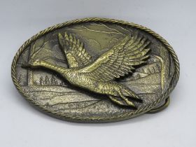 A Great American Buckle Co Chicago duck in flight belt buckle c1980s, serial number 470,