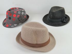Two 100% wool Trilbys together with another Trilby. Three items.