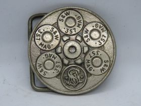 A c1980s Smith & Wesson belt buckle in .357 MAG shell pattern, copyright mark to back.