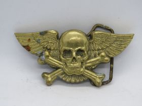 A brass c1979 Baron Buckle 'Deaths Angel' winged skull and crossbones belt buckle.