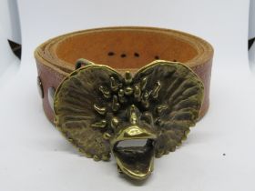 A vintage leather belt with brass buckle.
