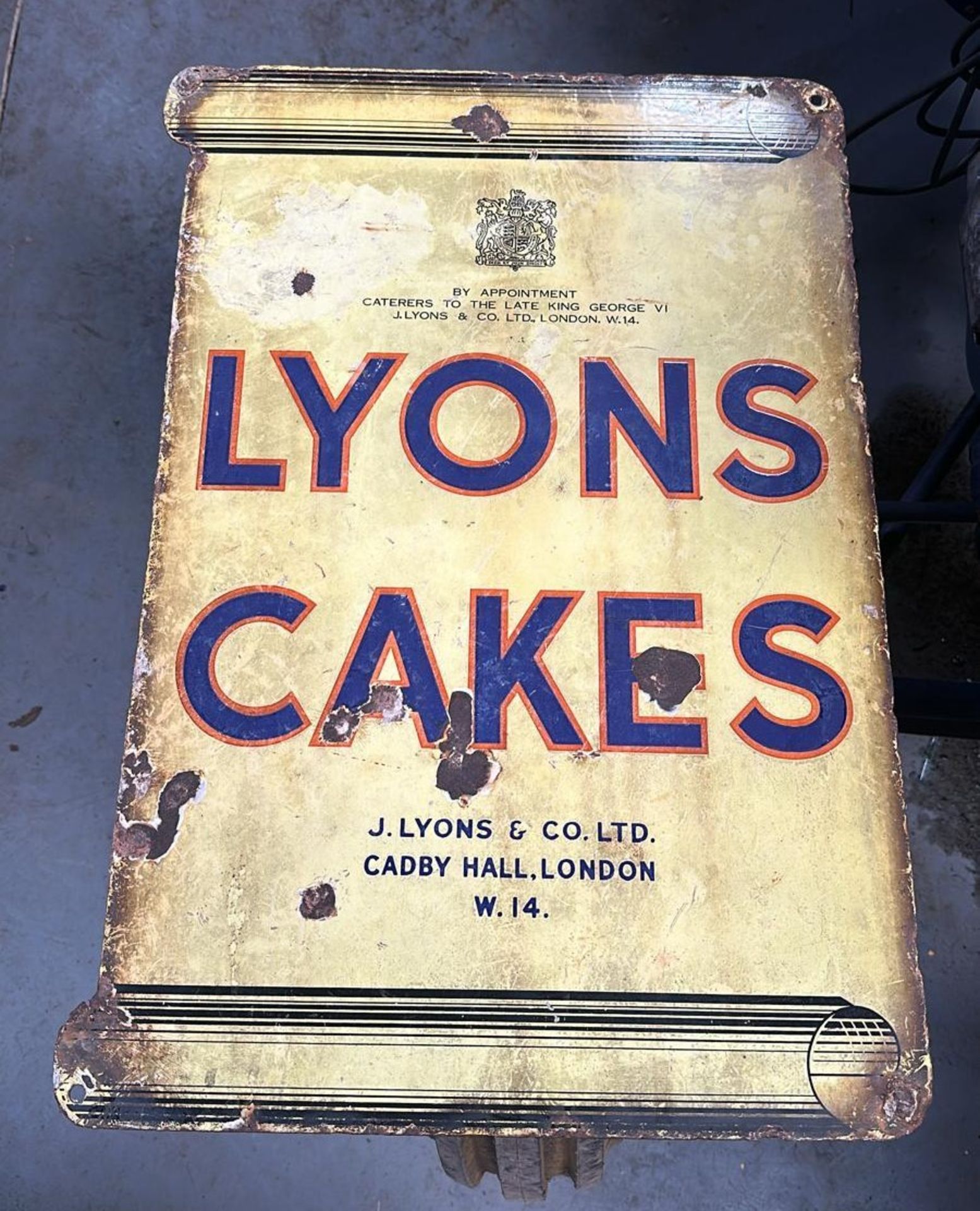 A vintage enamelled advertising sign for Lyons Cakes, approx 63 x 45cm (25 x 17").