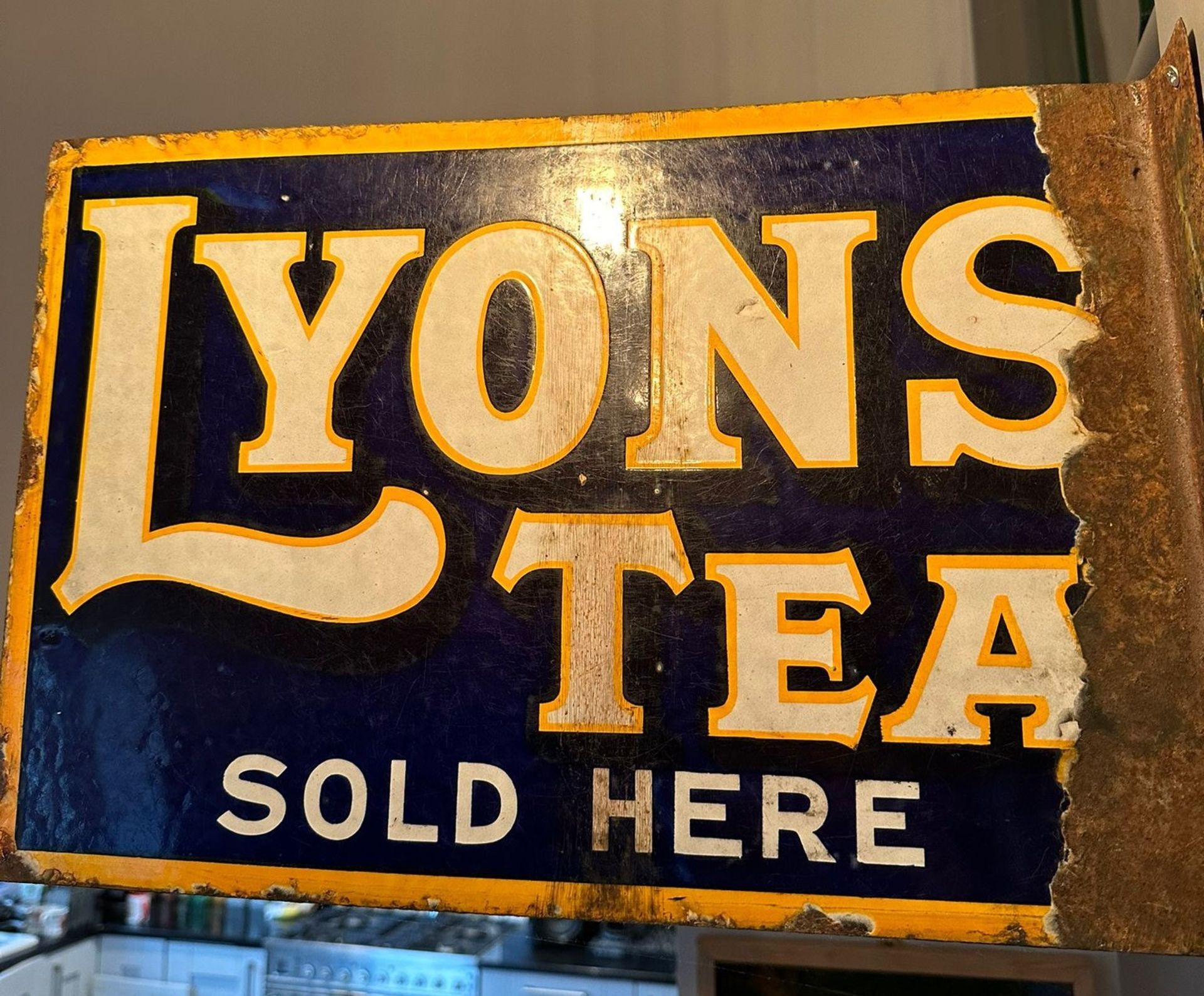 A vintage double-sided enamelled advertising sign for Lyons Tea, wall mounted,