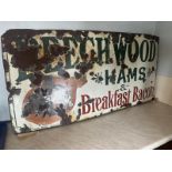 A vintage enamelled advertising sign for Beechwood Hams & Breakfast Bacon,