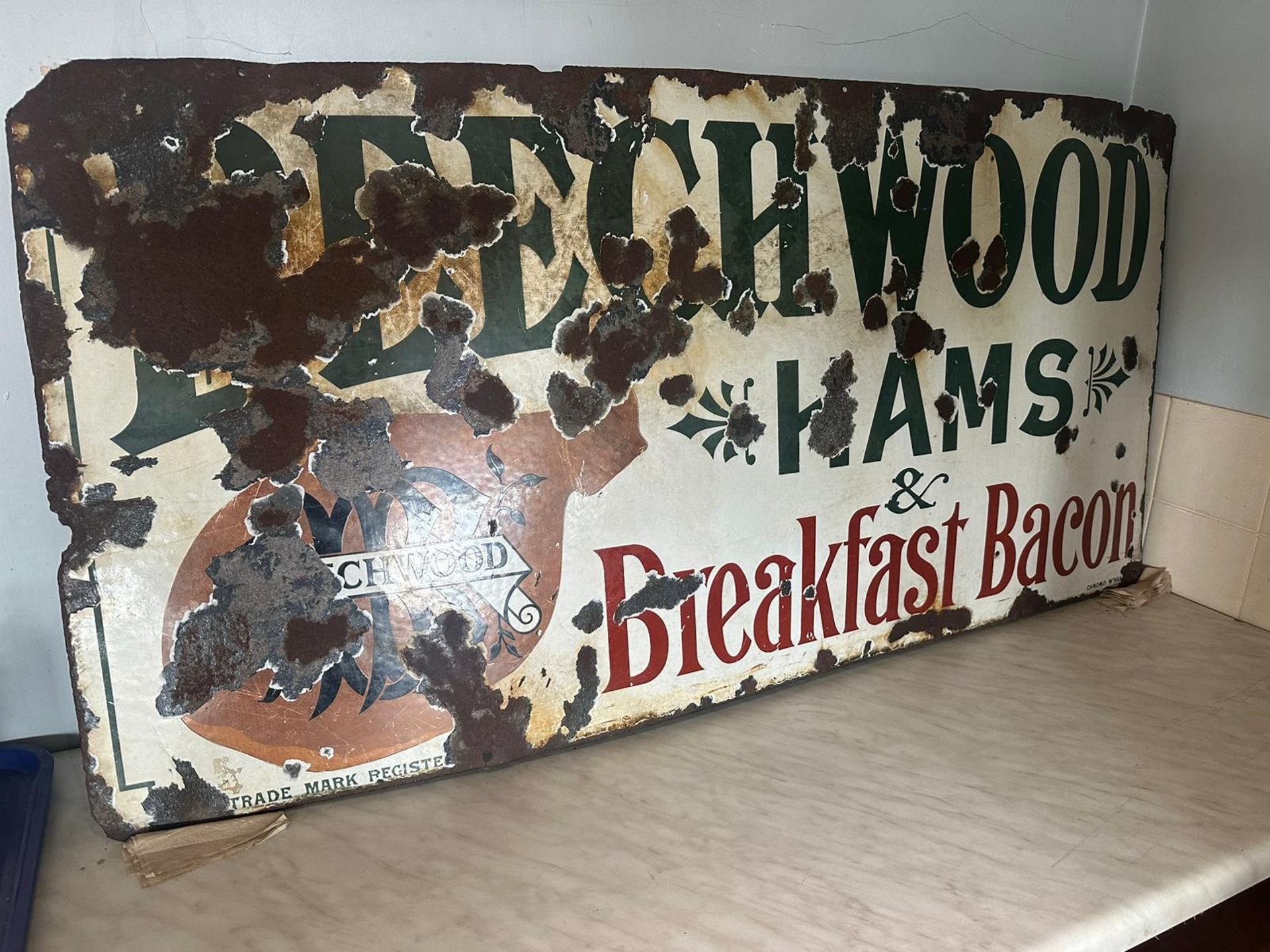 A vintage enamelled advertising sign for Beechwood Hams & Breakfast Bacon,