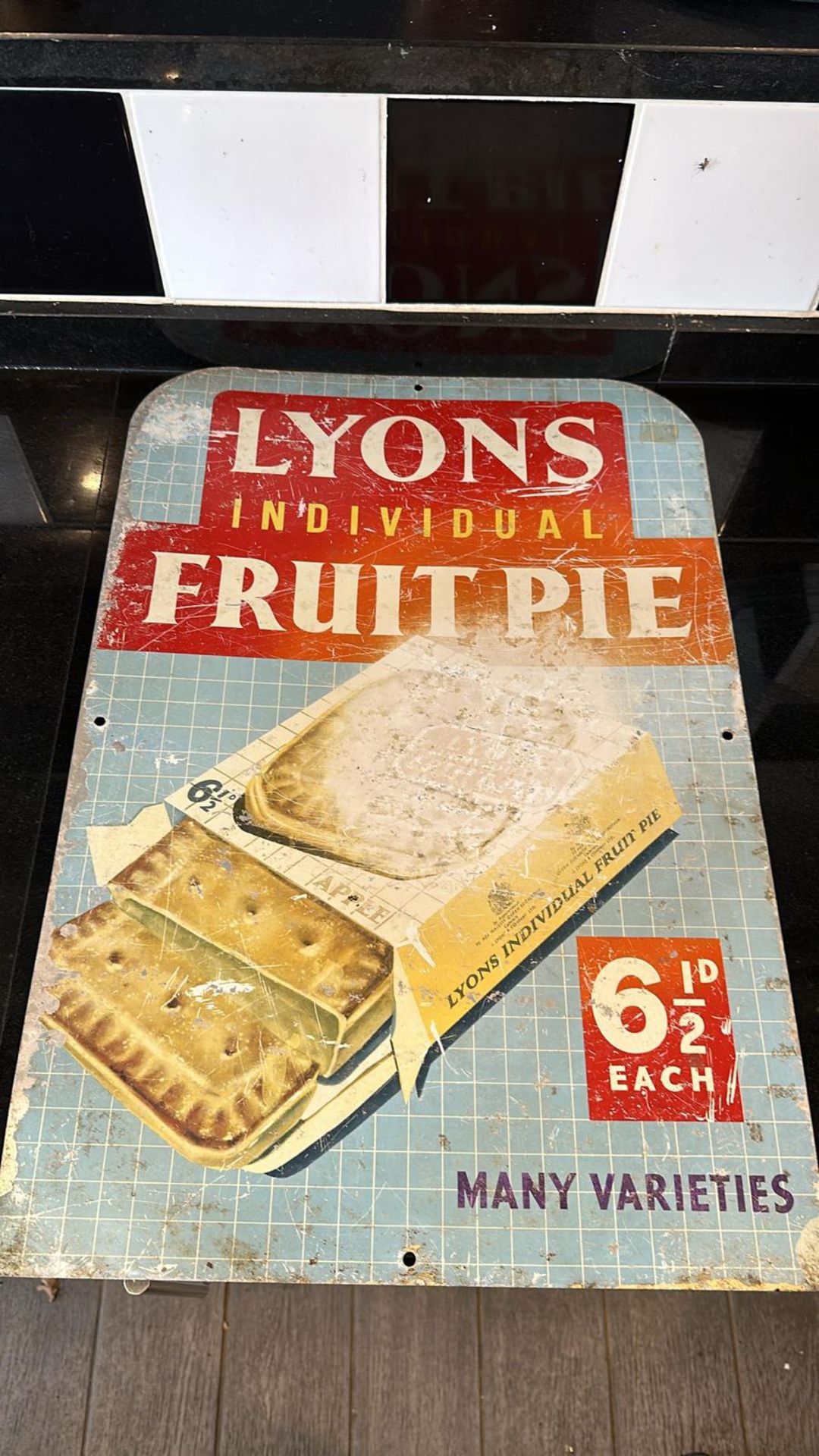 A vintage enamelled advertising sign for Lyons Individual Fruit Pie, approx 58 x 40cm (23 x 16").