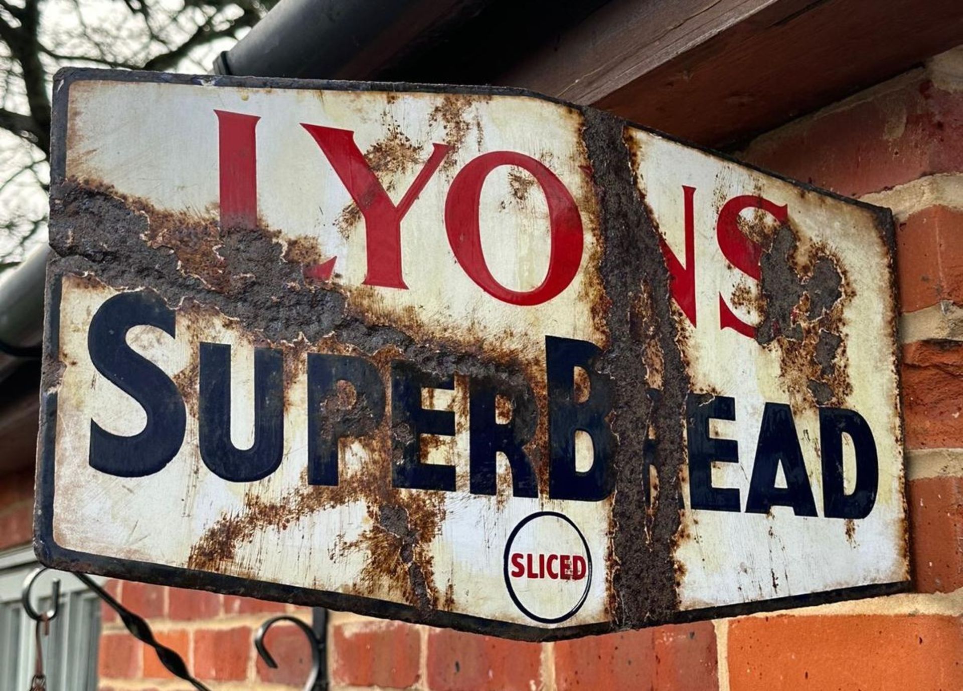 A vintage enamelled double-sided advertising sign for Lyons SuperBread, wall mounted,