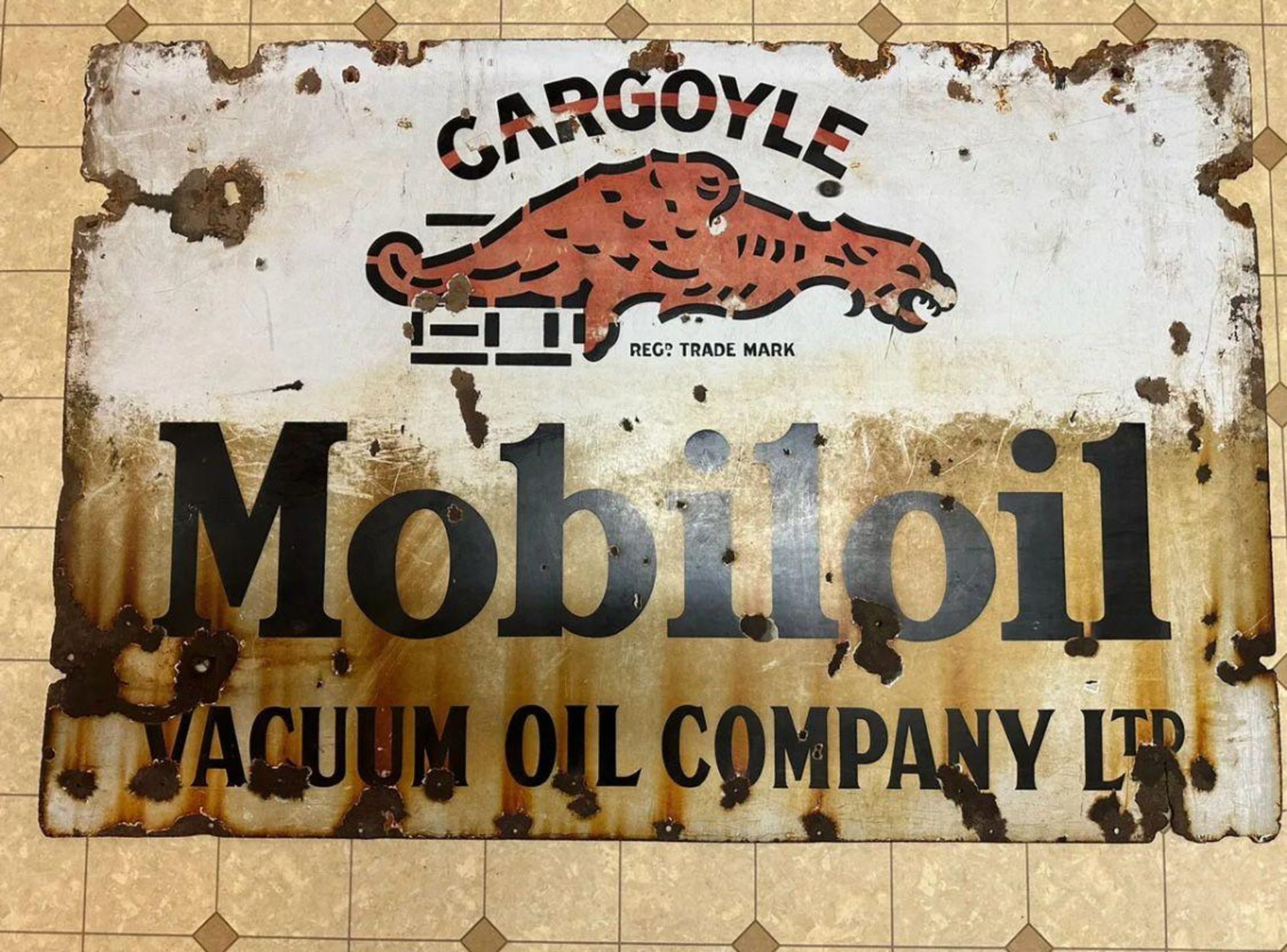 A vintage enamelled advertising sign for Mobiloil Gargoyle, approx 115 x 77cm (45" x 30").