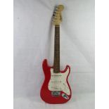 A Fender Squier Mini electric guitar in red.