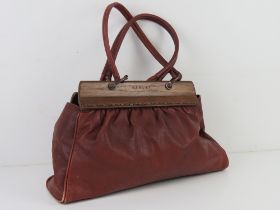 Radley; a red leather handbag with wooden dog keychain upon, pen marks noted to lining,