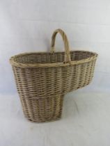 A large wicker stairs basket with loop handle.