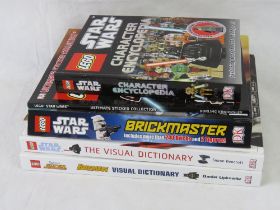 A quantity of Lego books, one with Han Solo Star Wars minifigure within.