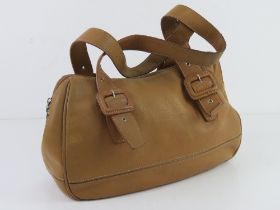 Lacoste; a sand coloured leather handbag, mark noted, 35cm wide.