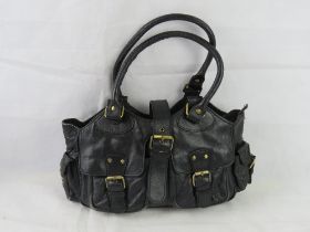 A black handbag by Oriano leather goods..