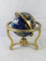 A lapis lazuli and semi precious gemstone set revolving globe with compass to base.