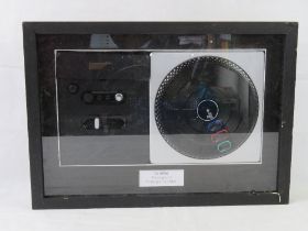A framed and mounted DJ Hero Playstation 3 Prototype Turntable.