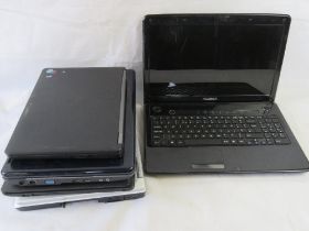 Five assorted laptops - four showing obvious damage of missing parts.