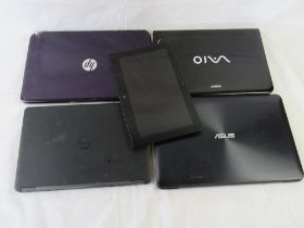 Five assorted laptops/tablet showing obvious damage of missing parts.