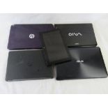 Five assorted laptops/tablet showing obvious damage of missing parts.