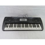 An electric keyboard. Disclaimer: electrical items are sold as untested and without guarantee.