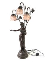 A large bronze table lamp in the Art Nouveau style having female figure with ivy leaves and three