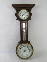 A barometer with clock and mercury thermometer over, simple carved oak case.