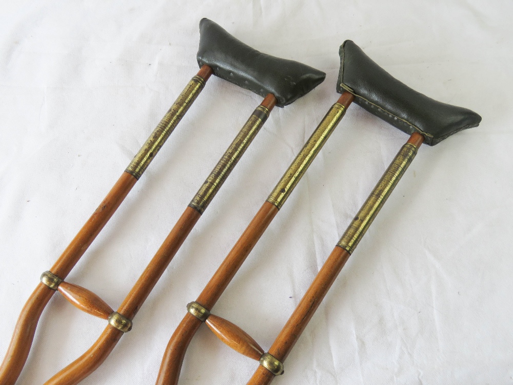 A pair of vintage brass mounted crutches, with sprung leather supports. - Image 2 of 2