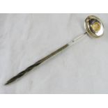 A punch ladle with inset coin from 1791.