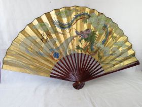 A large Japanese wall fan having dragon decoration and signature upon.
