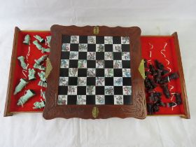 A contemporary Chinese folding chess board with drawers for pieces, 48 x 48cm open.