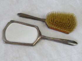 A hallmarked silver hairbrush and hand mirror set.