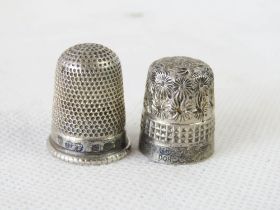 A hallmarked silver thimble together with a Charles Horner Dorcas thimble.