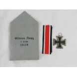 A WWII German Iron Cross 2nd Class in original 'Eisernes Kreuz' paper packet, with ribbon,